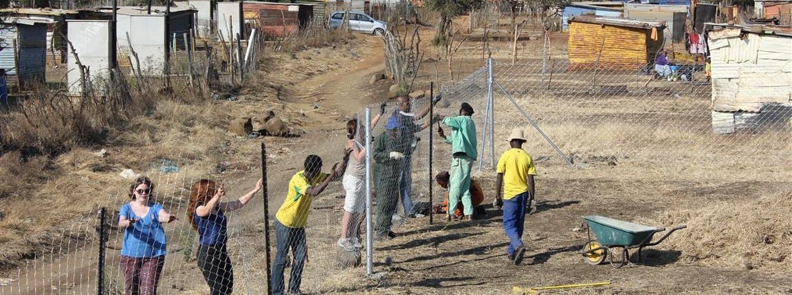 Volunteers putting up fencing in Nkaneng at site for new creche  (South Africa)