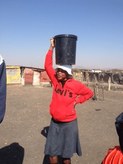 This is Emma, a Tapalogo (one of Serve’s partners) ‘Home- Based Care’ Worker. Here she is pictured fetching water for a vulnerable lady living on her own who was too weak to get her own water. She works in Freedom Park and goes around patients’ homes checking up on if they are too ill to come to the clinic and making sure they take their ARTs.