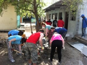 The SERVE crew hard at work mixing cement